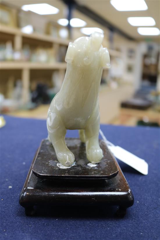 Two Chinese celadon jade figures of a fisherman and a lion-dog, 6.2 and 11cm, wood stands
